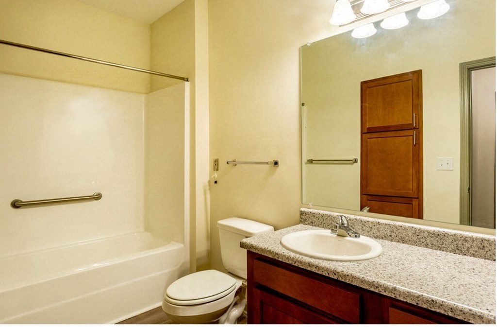 A bathroom with a toilet, sink, and bathtub.