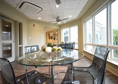 a dining room with a glass table and chairs