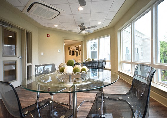 a dining room with a glass table and chairs