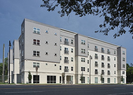 a large apartment building on the side of a street