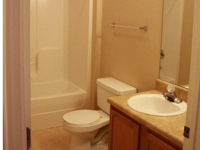 a bathroom with a sink toilet and a shower