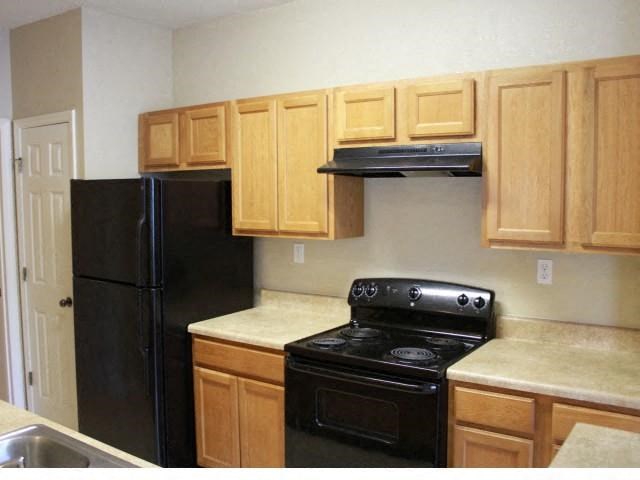 a kitchen with a stove and a refrigerator