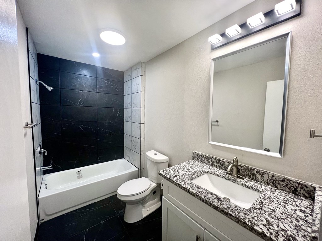 a bathroom with a sink toilet and a tub