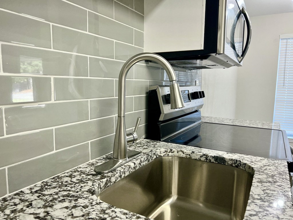 a kitchen with a sink and a chrome faucet