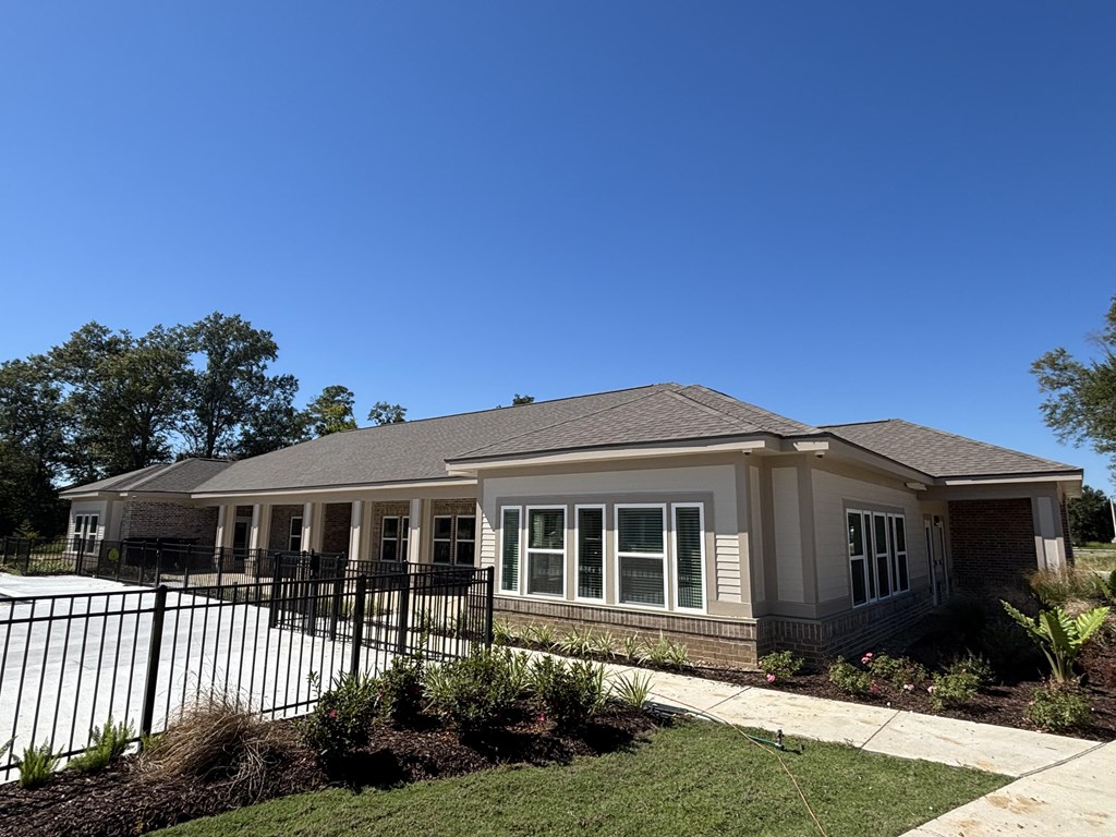 A house with a black fence in front of it.
