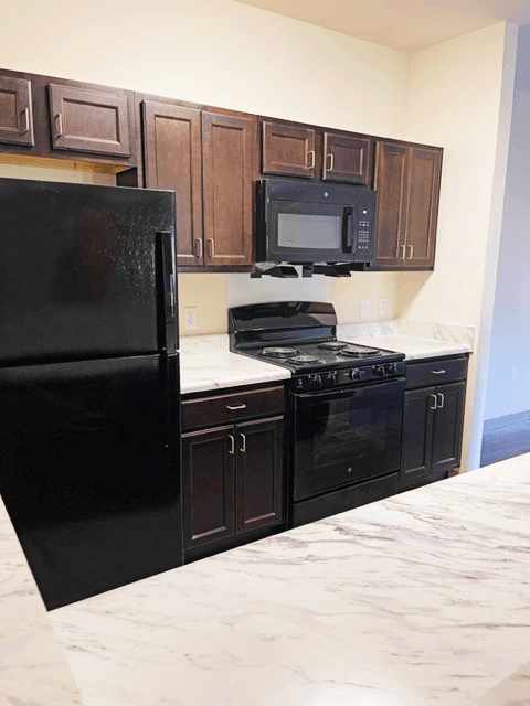 a kitchen with black appliances and white counter tops