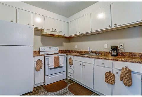 a kitchen with white appliances and white cabinets