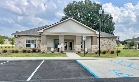 A building with a parking lot in front of it.at Arbours at Moores Mill, Huntsville, 35811