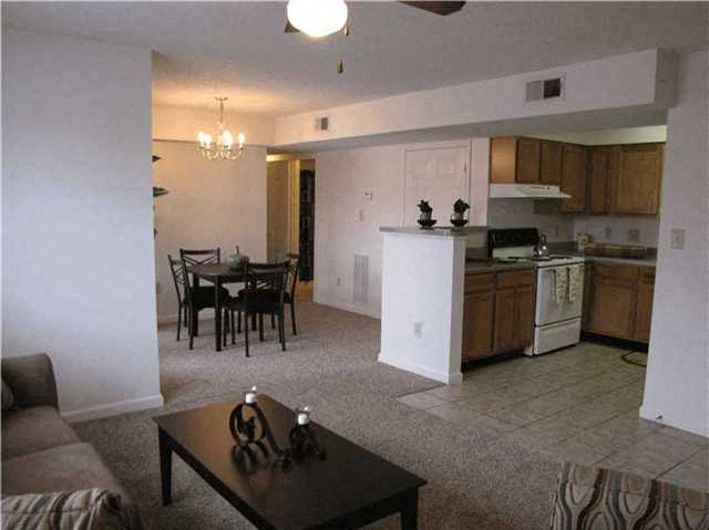 a living room with a kitchen and a dining room
