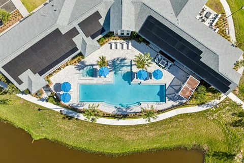 An aerial view of a house with a pool and a patio area.