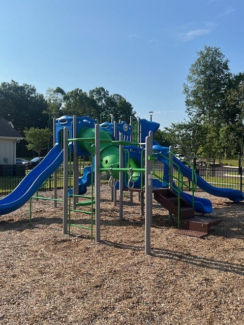 A Playground With a Blue and Green Slide at Arbours at Quincy, Quincy, FL, 32351