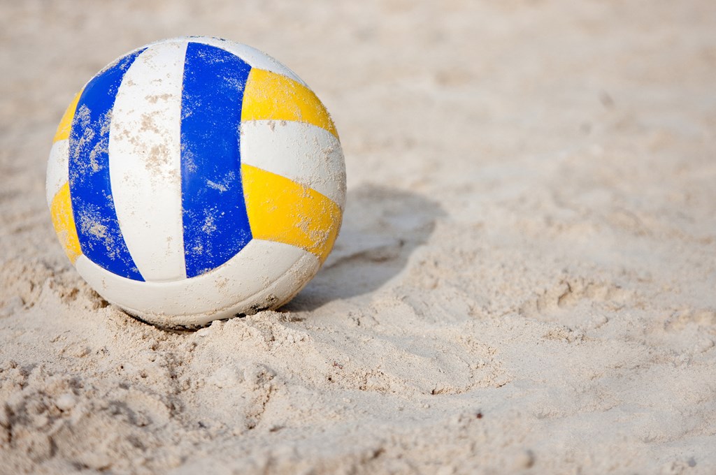 a volleyball sitting in the sand on the beach