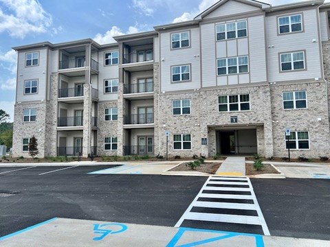 A large building with a parking lot in front of it.at Arbours at Moores Mill, Alabama, 35811