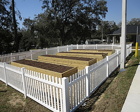A white picket fence with brown boards on top.
