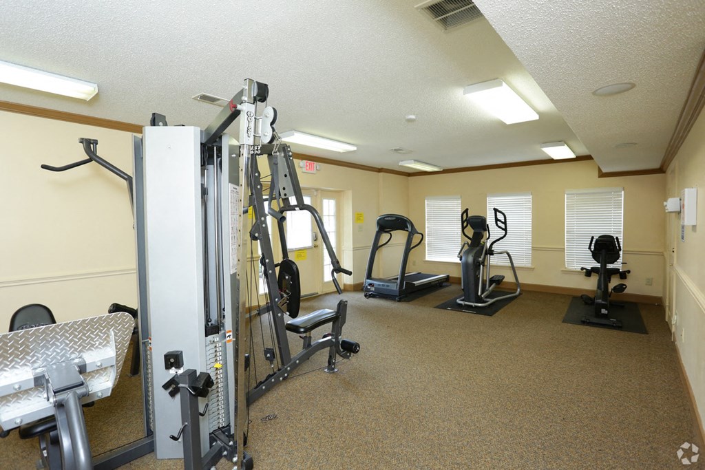 a gym with weights and other exercise equipment in a room