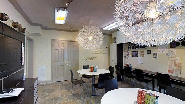 a dining room with tables and chairs and chandeliers