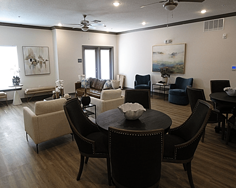 A living room with a dark brown table and chairs.