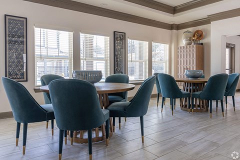 A dining room with blue chairs and a wooden table.