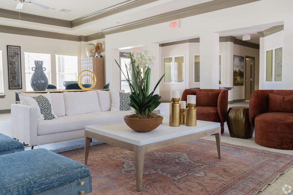 A living room with a white couch, a coffee table, and a rug. at Arbours at Villa Rica, LLC, Georgia