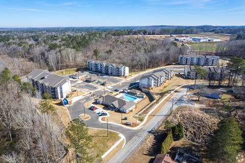 A bird's eye view of a residential complex with a swimming pool.