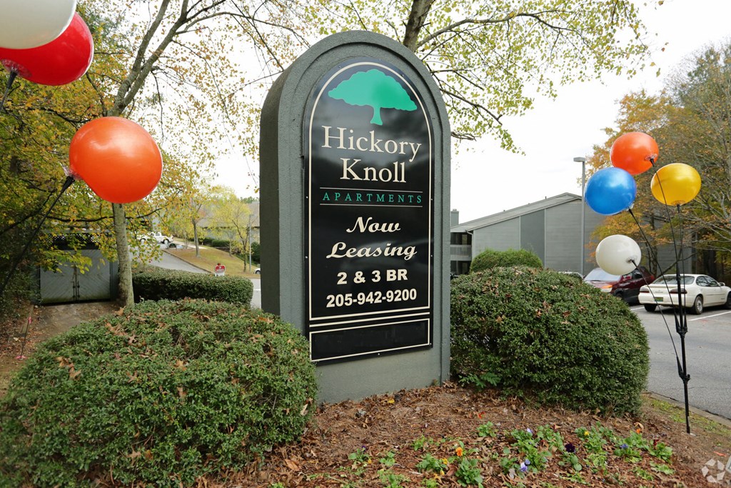 a sign for the hickory knob new learning center with balloons