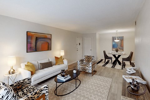 A living room with a zebra print chair and a white couch.