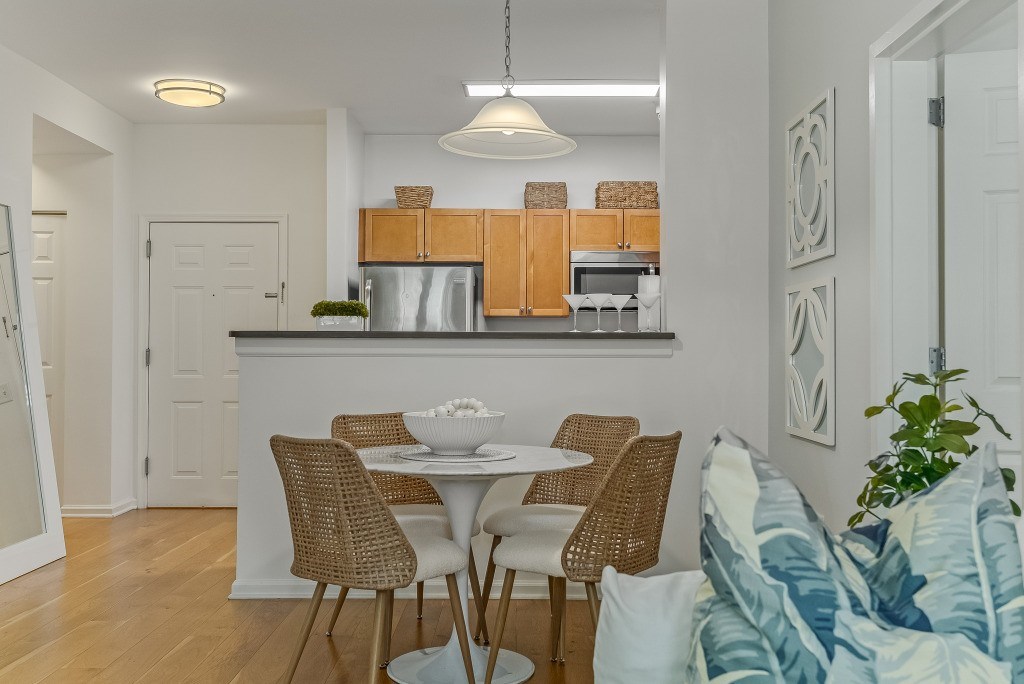 A kitchen with a table and chairs.