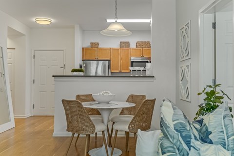 A kitchen with a table and chairs.