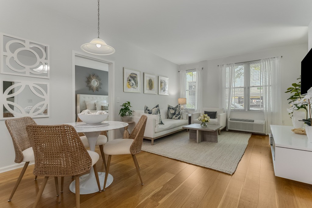 A modern dining room with a white table and chairs.