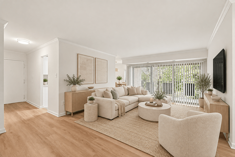 A living room with a white couch and a white chair.
