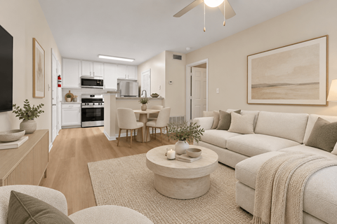 A modern living room with a white sofa and a coffee table.