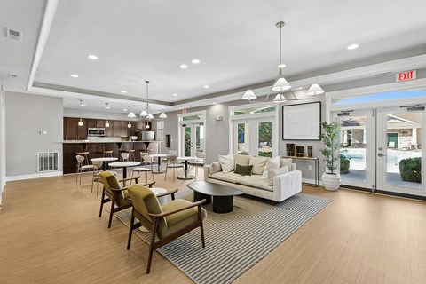 A spacious living room with a striped rug and a white sofa.