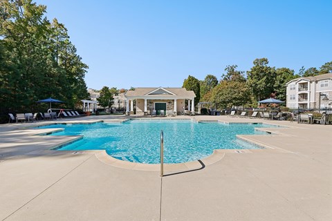 A large swimming pool with a building in the background.