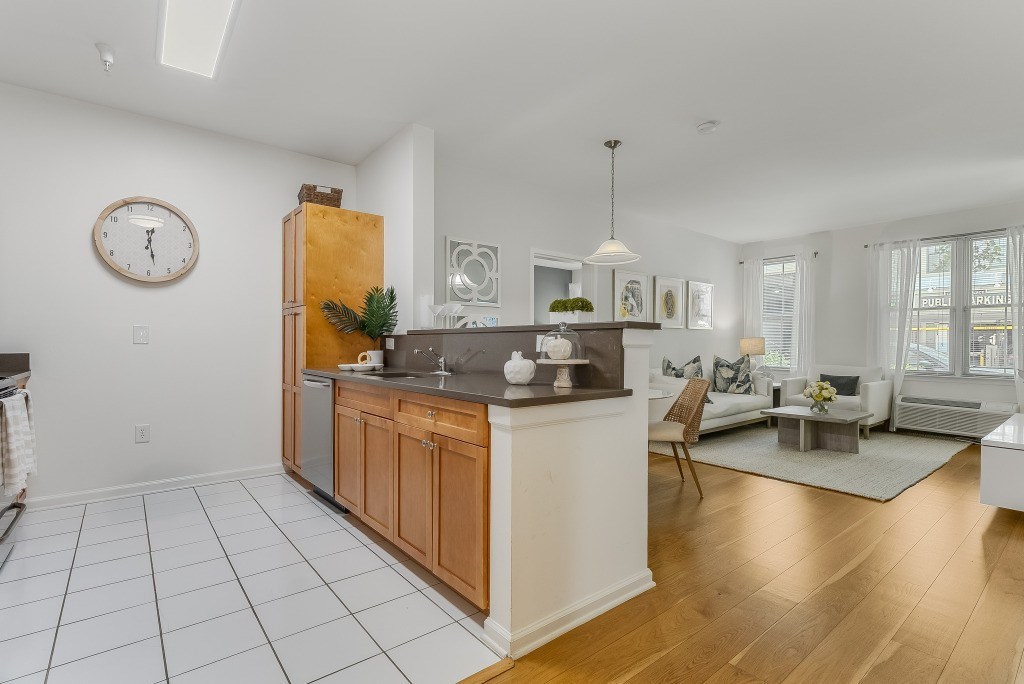A kitchen with a wooden island and a clock on the wall.