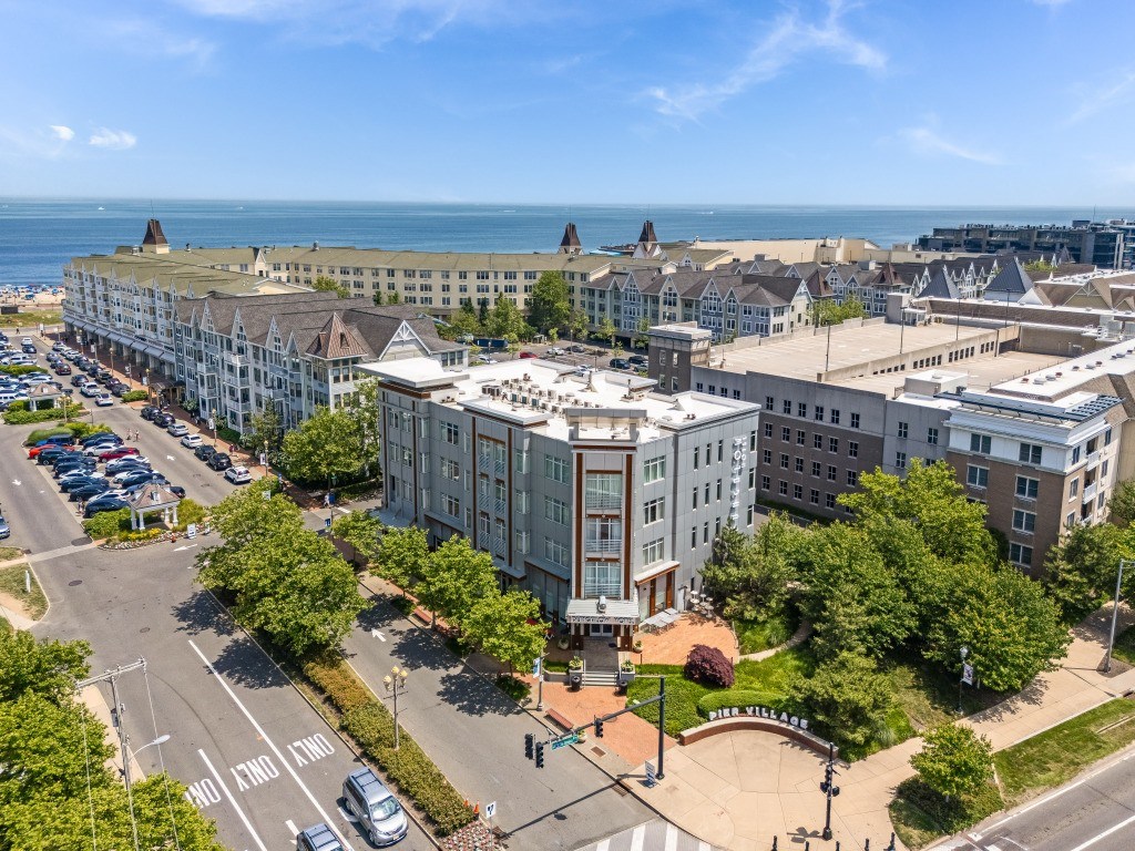 A large white building with a green lawn in front of it.