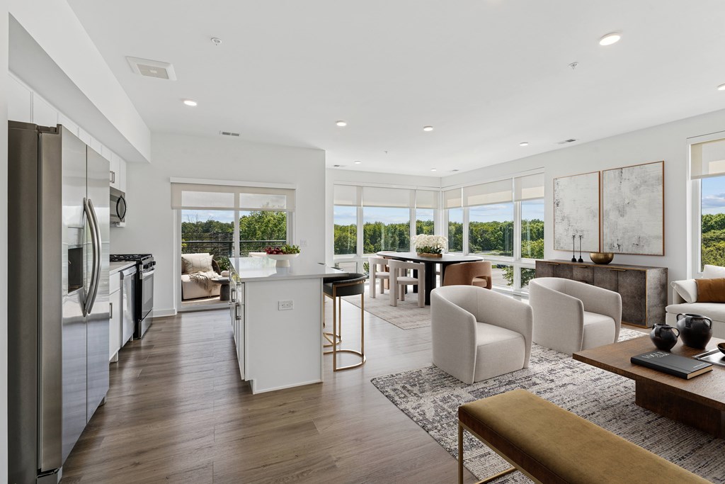 A modern kitchen with a refrigerator, sink, and stove.