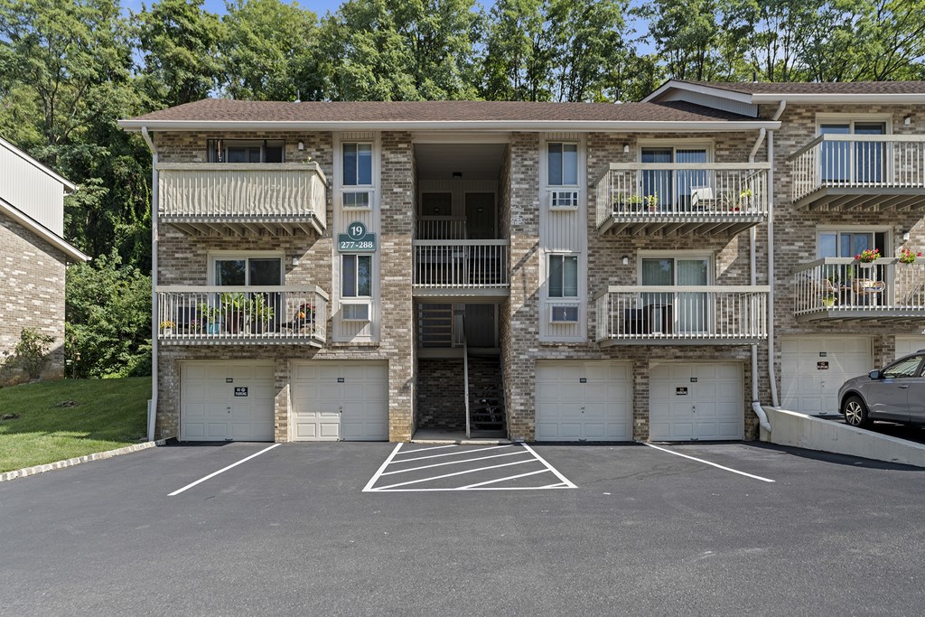 Apartment building with a parking lot in front at Atlantic Pointe Apartments, New Jersey, 07716
