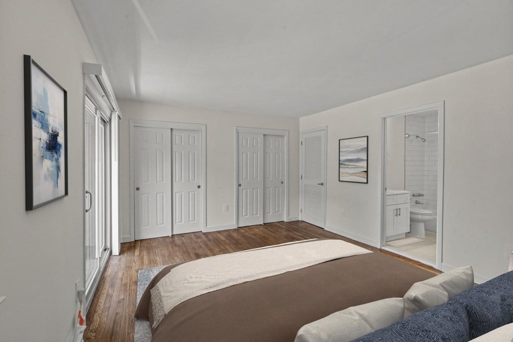 A bedroom with a large bed and a painting on the wall at Atlantic Pointe Apartments, Atlantic Highlands 