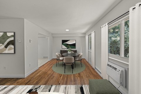 A living room with a couch, chairs, and a painting on the wall.
