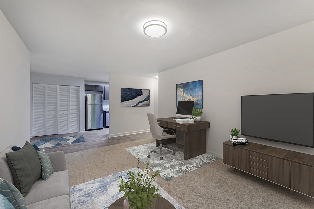 a living room with a couch and a desk with a tv