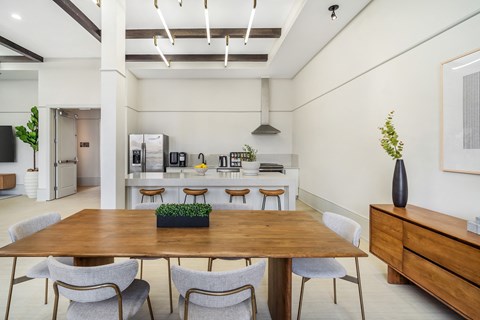 A dining room with a wooden table and chairs at The Addison, Baton Rouge