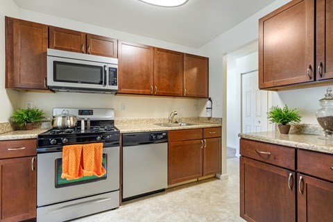 A kitchen with a stove top oven and microwave.