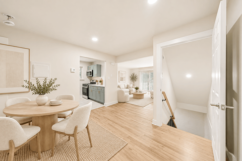 A dining room with a round table and chairs.