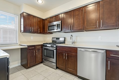 A kitchen A kitchen with brown cabinets and stainless steel appliances. at Chatham Hill, New Jersey, 07928