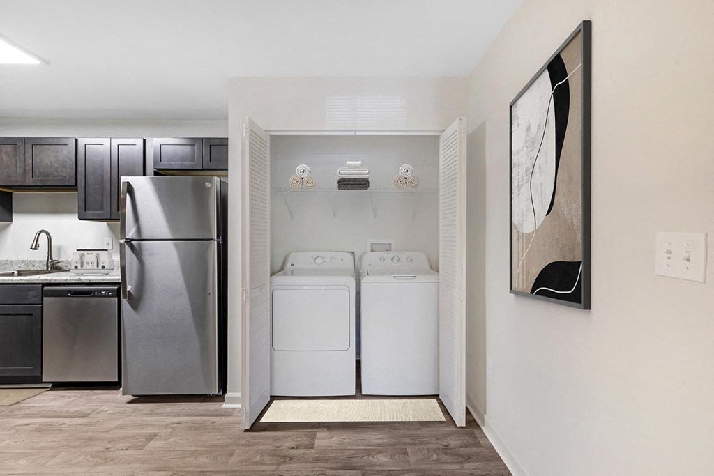 a washer and dryer in a laundry room with a refrigerator