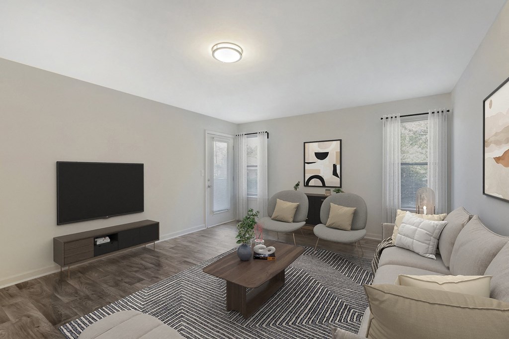 a living room with a couch and chairs and a television