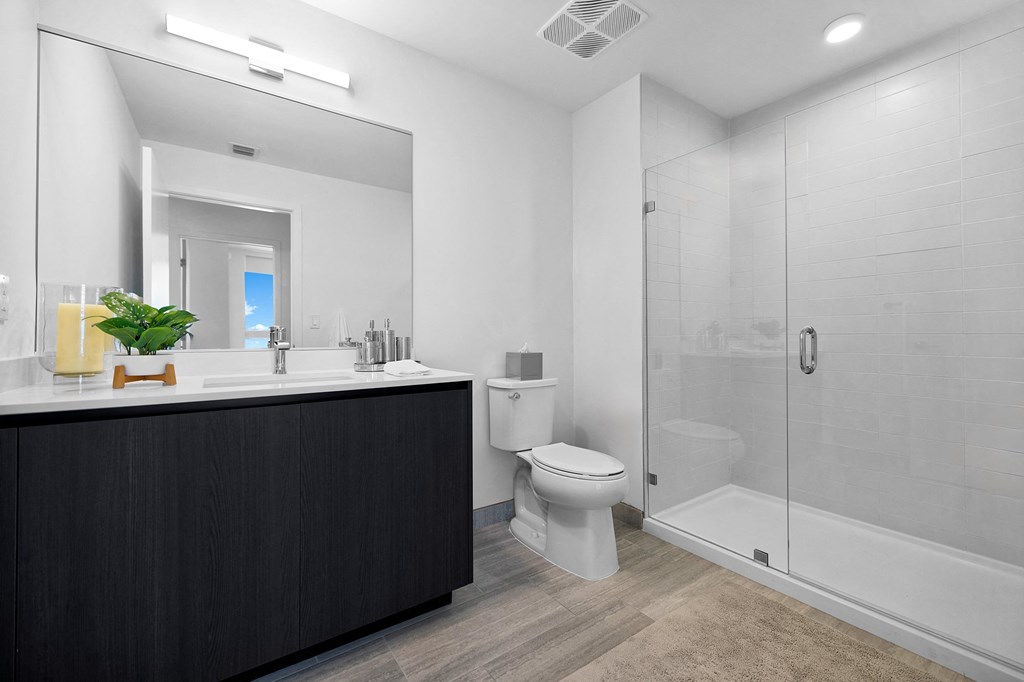 a bathroom with a toilet sink and shower