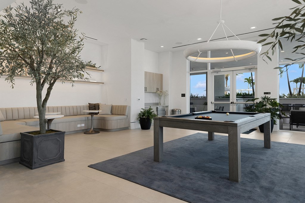 a game room with a pool table and a tree