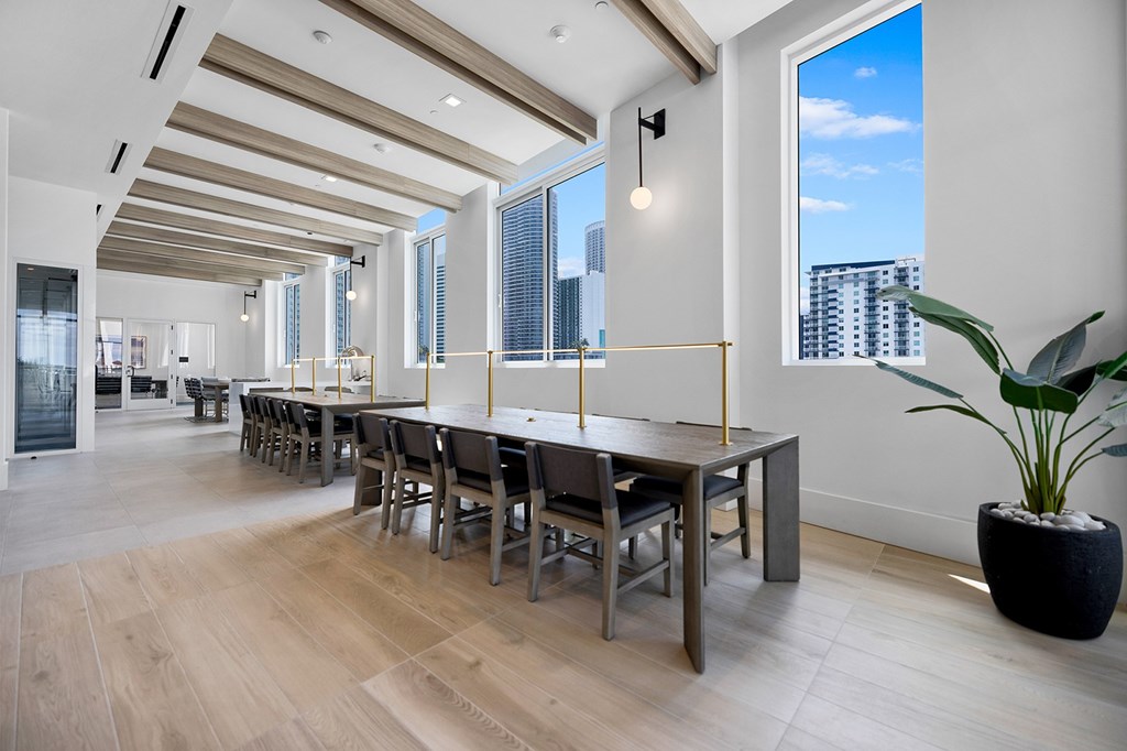 a large dining room with a long wooden table and chairs