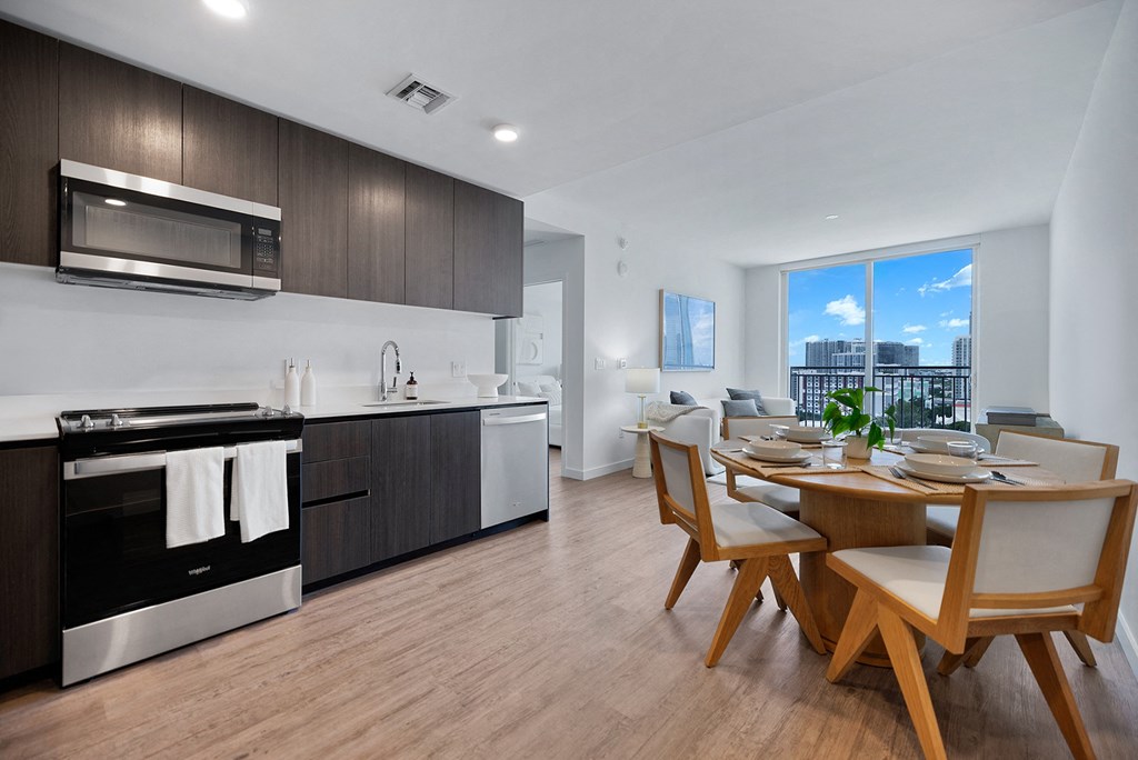 a kitchen and dining room with a table and chairs